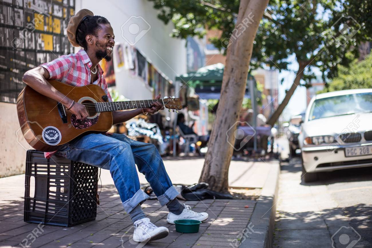 97263080-a-busker-singing-and-playing-guitar-on-the-streets-of-johannesburg-an-african-man-playing-the-guitar.jpg